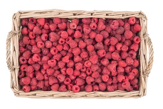 Raspberries in the basket isolated on white background. Top view.