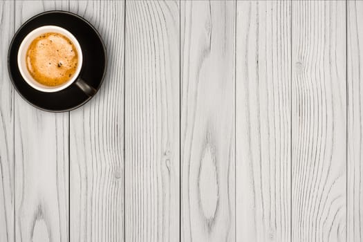 Coffee cup on white wooden table background. Top view with copy space
