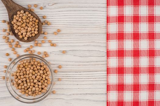 Chickpeas on old wooden table. Abstract background, empty template. Top view.