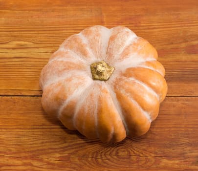 Pumpkin on a surface of old wooden planks
