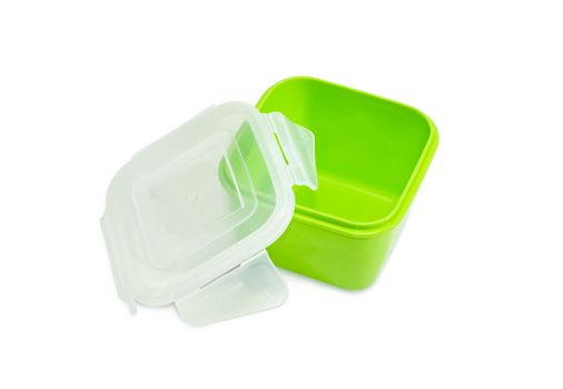 Green reusable plastic food storage container for home use with open translucent cover on a light background

