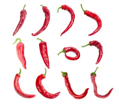 Top view of the several red peppers chili with a various shapes of pods are laid out in three rows on a light background
