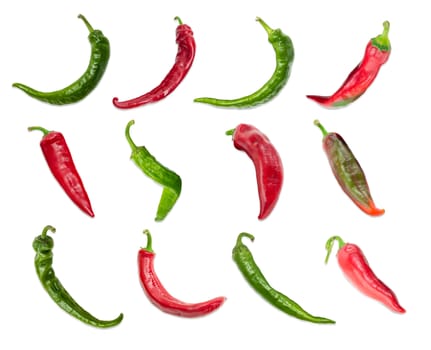 Top view of the several red and green peppers chili with a various shapes of pods are laid out in three rows on a light background
