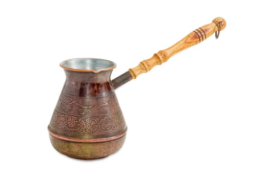 Old copper coffee pot with a wooden handle on a light background
