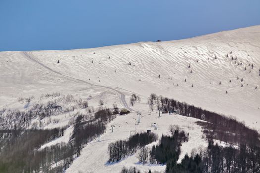 Ski elevator on winter sunny day. Beautiful alps winter panoramic aerial view