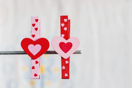 Colorful hearts on a white background with a metal bar.