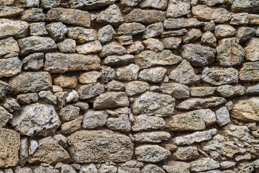 Part of an old stone wall with clay masonry