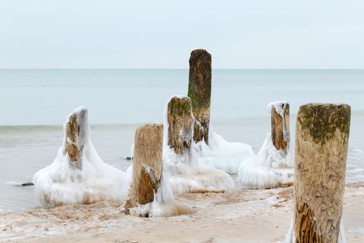 Ice on the breakwater in the form of skirts in the Baltic Sea