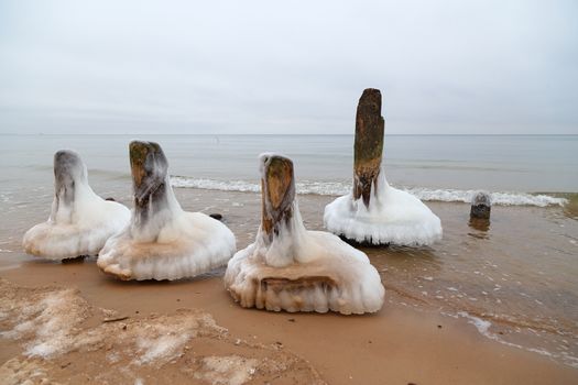 Ice on the breakwater in the form of skirts in the Baltic Sea