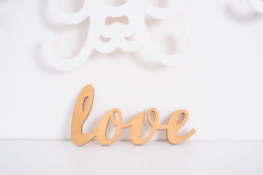 wooden word love on a white background in studio.