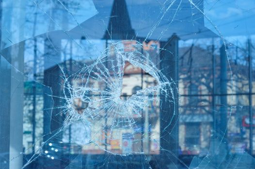 bullets pierced the glass in the window in city street