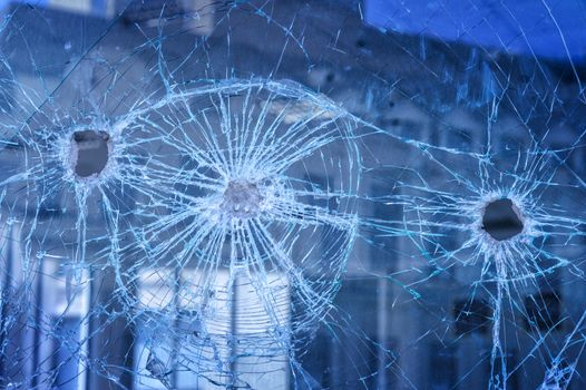 bullets pierced the glass in the window in city street