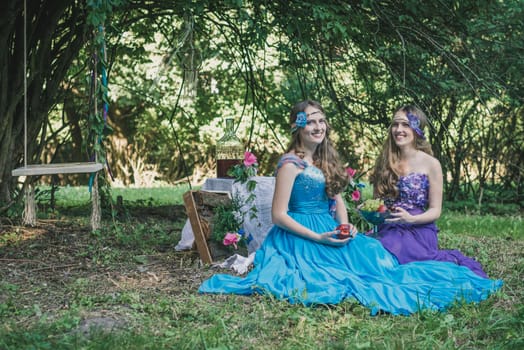 two adult sisters with fruit in the garden