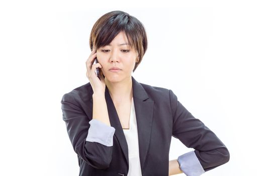 Chinese businesswoman in casual office clothes on cell phone looking annoyed