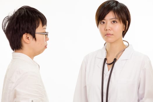 Concerned Chinese female doctor with patient