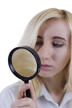 Portrait of beautiful young woman with magnifier glass