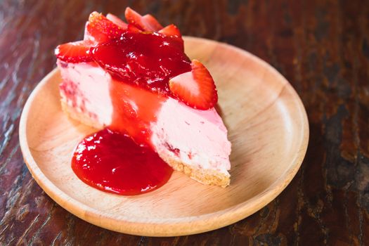 homemade cheesecake with strawberries on wooden dish