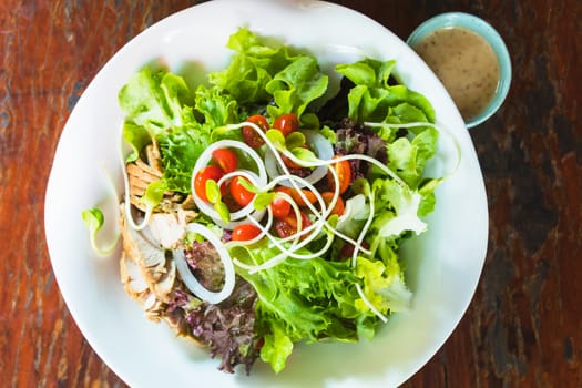 roasted pork salad with vegatables on white dish