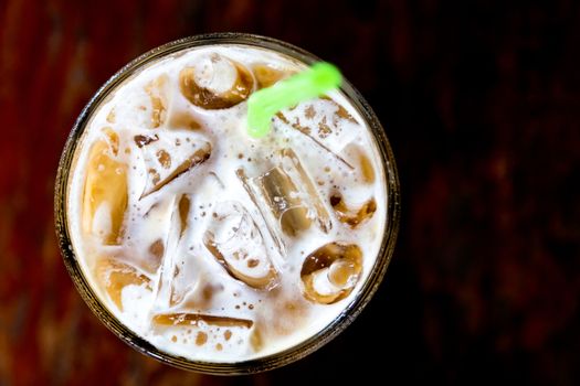 top view ice coffee in glass with straw