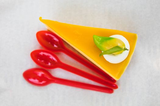 homemade mango cheesecake with red spoons