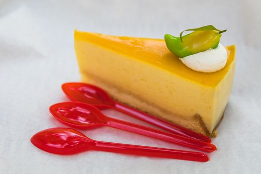 homemade mango cheesecake with red spoons