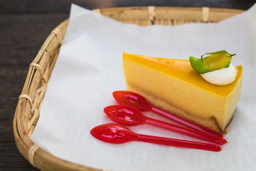 homemade mango cheesecake with red spoons