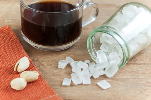 Coffee and best rock sugar white in a Glass Jar on the wood background. Pure cane sugar for natural.