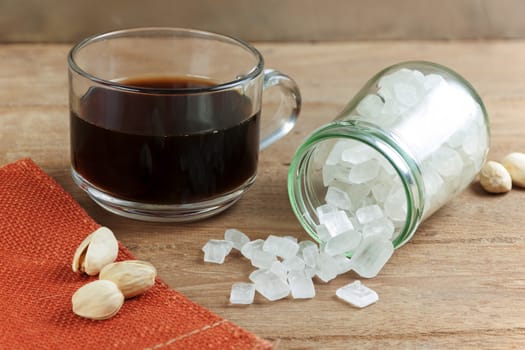 Coffee and best rock sugar white in a Glass Jar on the wood background. Pure cane sugar for natural.