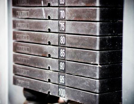 Stack of rusty metal weights in gym bodybuilding equipment. Bodybuilding concept. Hign contrast and monochrome color tone