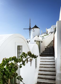 Oia town on Santorini island, Greece. Traditional and famous houses and churches with blue domes over the Caldera, Aegean sea