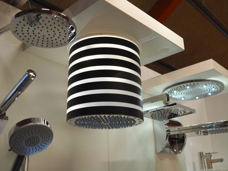 Display of modern trendy elegant design shower heads in a showroom