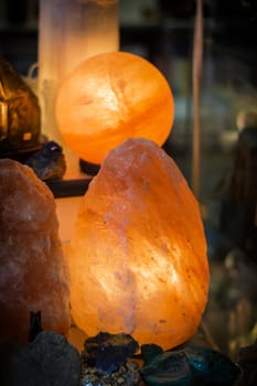 The lamp placed inside of the salt stone. Vertical indoors shot of Himalayan salt lamp