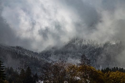 Mountains covered with snow and surrounded by clouds in the Alps