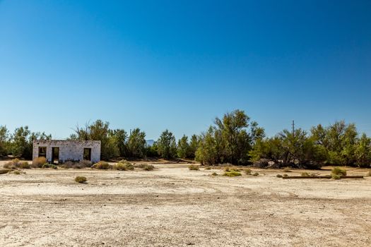 An abandoned building sits alongside the roadway near Death Valley Junction in the Funeral Mountains Wilderness Area, California.