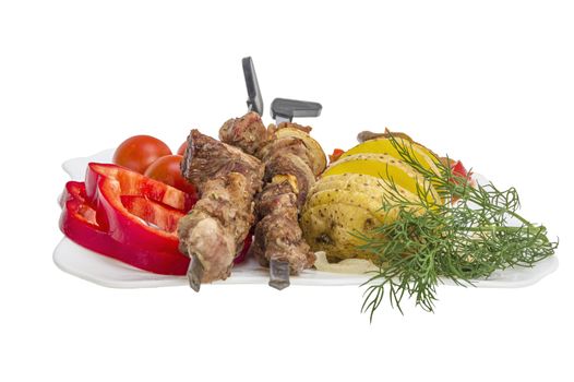 Kebabs grilled meat tomatoes and vegetables on white background 