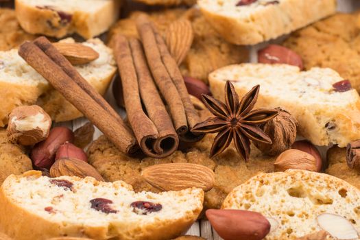 Cookies with almonds and raisins on the old wooden table. Selective focus.