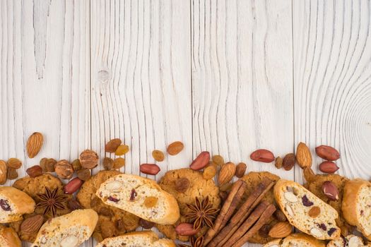 Cookies with almonds and raisins on the old wooden table. Top view.