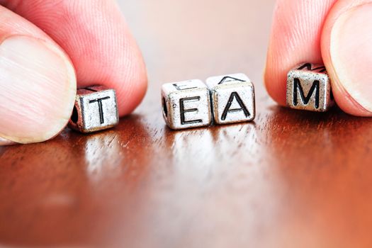 team concept business marketing letters placed on a desk in precious wood