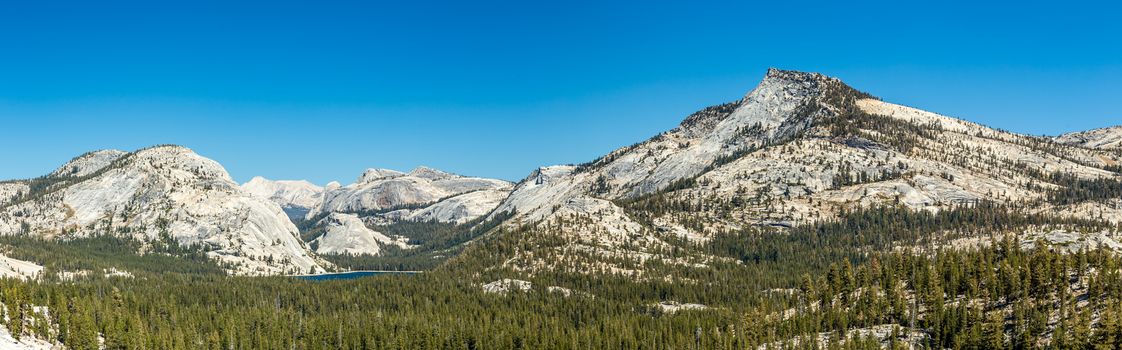 Tenaya Lake is an alpine lake in Yosemite National Park, located between Yosemite Valley and Tuolumne Meadows. The surface of Tenaya Lake has an elevation of 8,150 feet. The lake basin was formed by glacial action, which left a backdrop of light granite rocks. Today, Tenaya Lake is easily accessible by State Route 120 and is a popular lake for water activities.