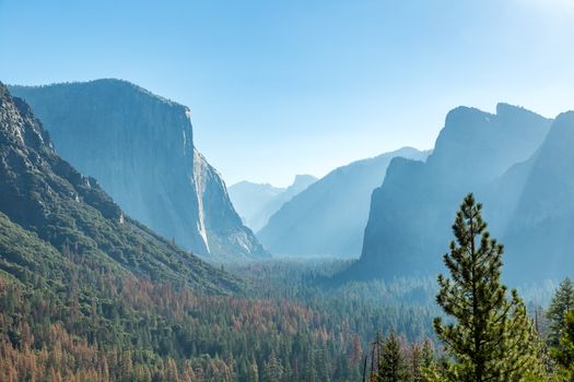 Tunnel View is a scenic overlook on State Route 41 in Yosemite National Park. The iconic and expansive view of Yosemite Valley from the view point have been seen and documented by visitors since it opened in 1933. Internationally renowned artists to casual tourists have painted, drawn, and photographed the dramatic scenery from here and nearby vantage points since the 19th century.