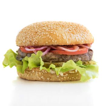 Tasty classical burger with meat cheese lettuce onion, tomato isolated on white