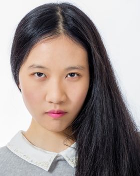 Portrait of serious looking Chinese teenage girl