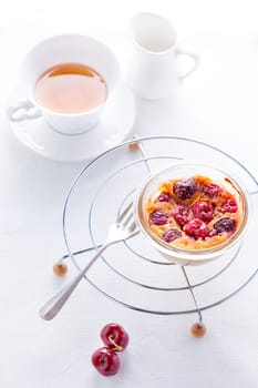 Clafoutis and tea served on a white surface