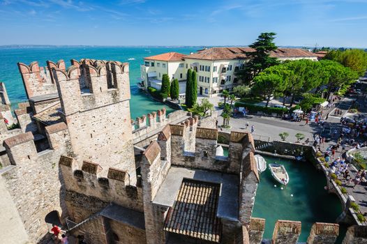 Sirmione, province of Brescia, Lombardy, northern Italy - 15th August 2016: people visiting the medieval castle Scaliger on lake Lago di Garda
