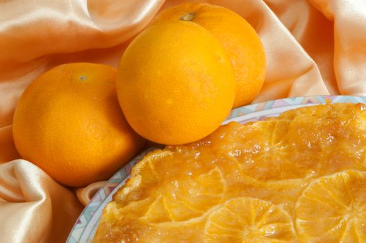 an orange homemade cake on fabric background