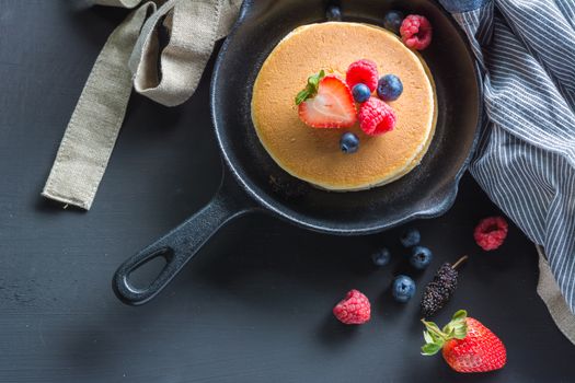 Selective focus Pancakes with blueberries  & raspberry on wood background