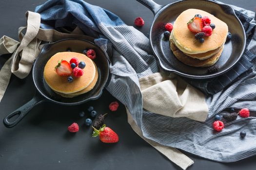 Selective focus Pancakes with blueberries  & raspberry on wood background