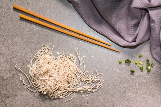 view top noodle and chopsticks on background