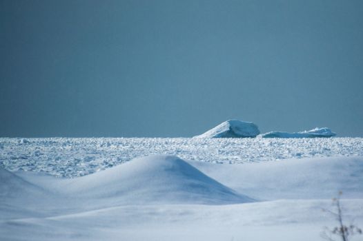 Wintry Lake huron icebergs and snow dunes landscape.