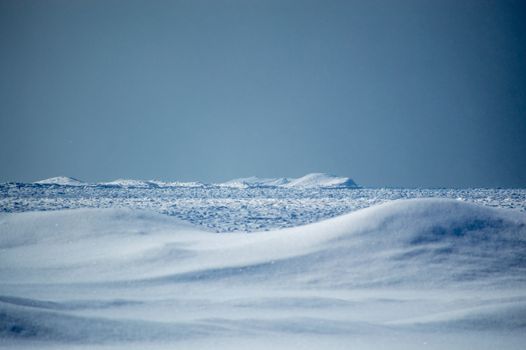 Wintry Lake huron icebergs and snow dunes landscape.